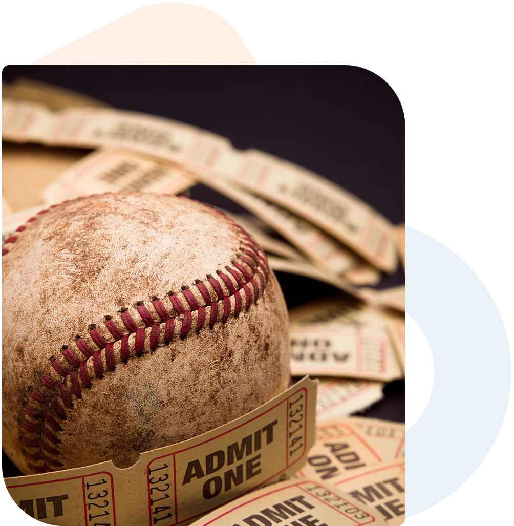 Vintage baseball with game tickets.