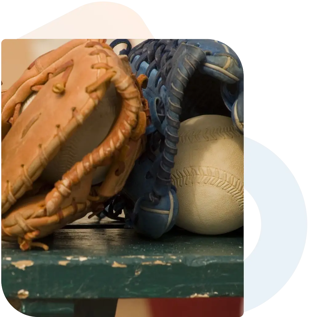 A baseball glove and ball on top of a table.